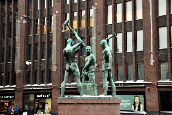 Хельсинки. Улица Aleksanterinkatu. Скульптура «Три кузнеца». Работа Феликса Нюлунда (1932). На самом памятнике и постаменте следы от бомбежек Хельсинки во время Второй мировой войны. 